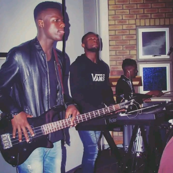 Kingdom Music team in front of backdrop